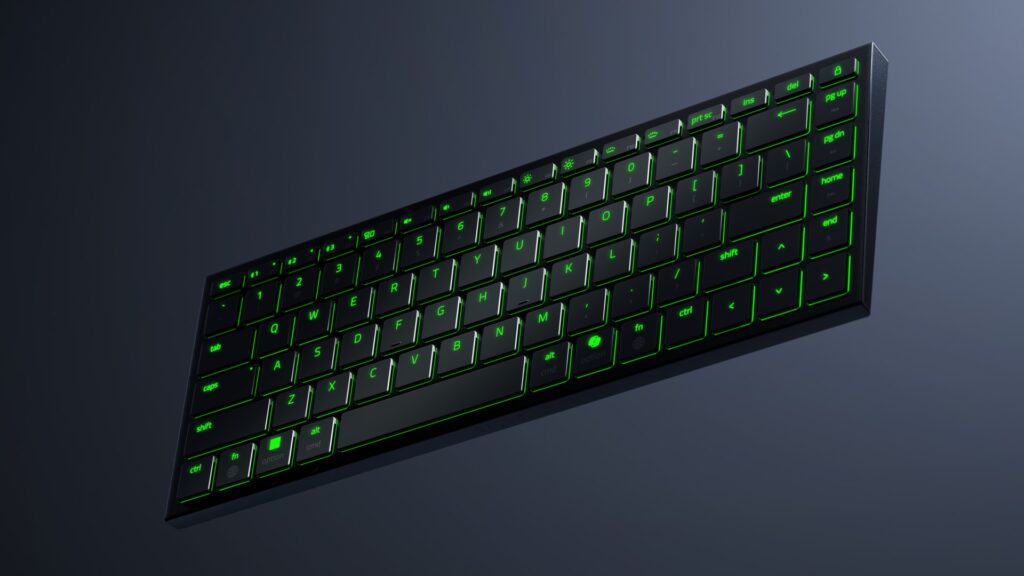 Razer Joro gaming keyboard with green RGB lighting on a gray background