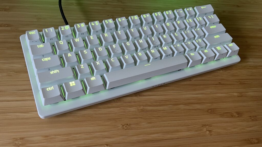 Razer Huntsman V3 Pro Mini gaming keyboard on a wooden desk